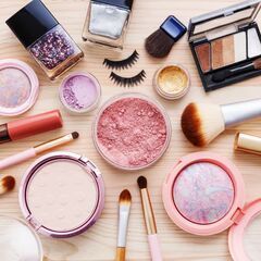 a table topped with lots of different types of makeup