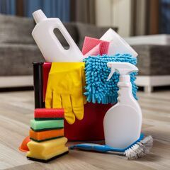 a pile of cleaning supplies sitting on top of a wooden floor