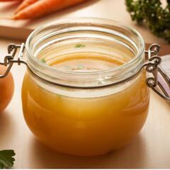 a glass jar filled with liquid sitting on top of a table