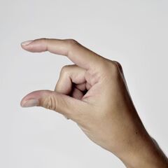 a person's hand holding something in the air