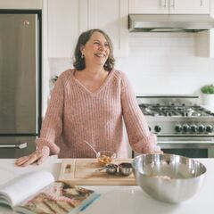 a woman standing in a kitchen next to a counter