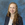 a woman with long hair smiling for a picture