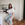 a woman sitting on a stool in a kitchen