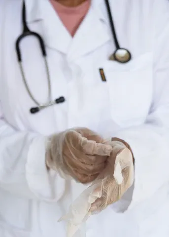 a person in a white lab coat holding something in their hands