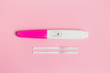 a pink and white pen sitting on top of a pink surface