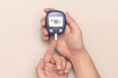 a person holding a blood pressure meter in their hand