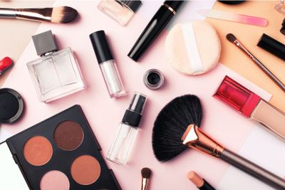 a table topped with cosmetics and makeup brushes