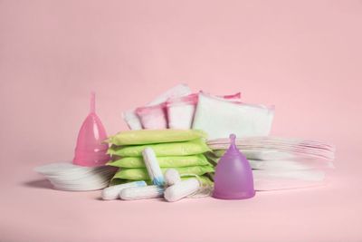 a pile of white and pink items on a pink background