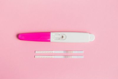 a pink and white pen sitting on top of a pink surface