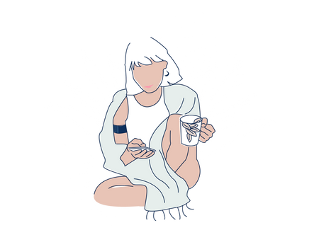 a woman sitting on the ground holding a cell phone