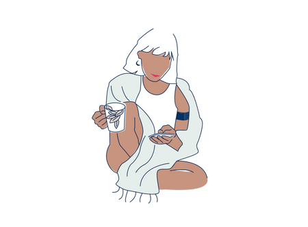 a woman sitting on the ground holding a cell phone