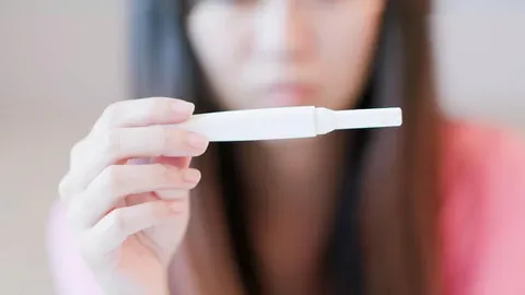 a woman holding a toothbrush in front of her face