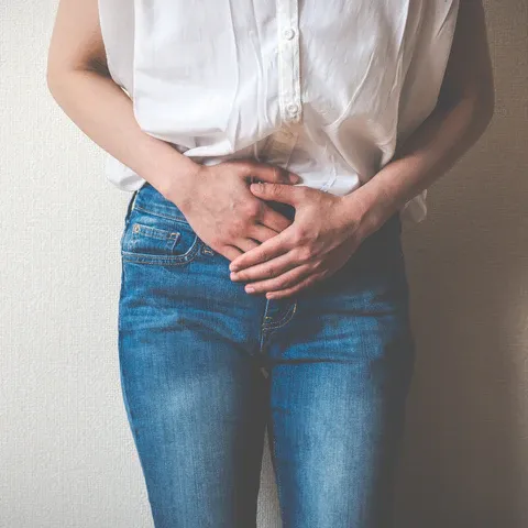 a woman with her hands on her stomach