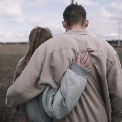 a man carrying and woman hugging