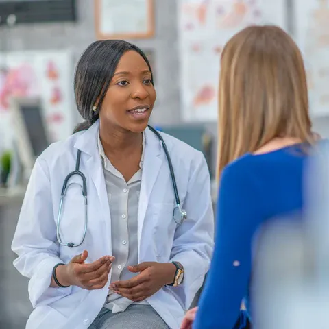 a female doctor talking to a female patient