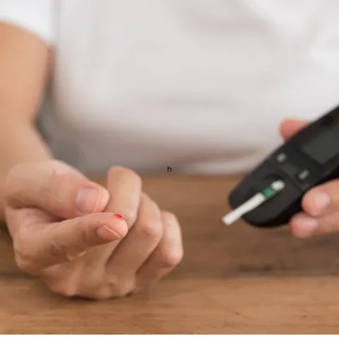 a person holding a remote control on a table