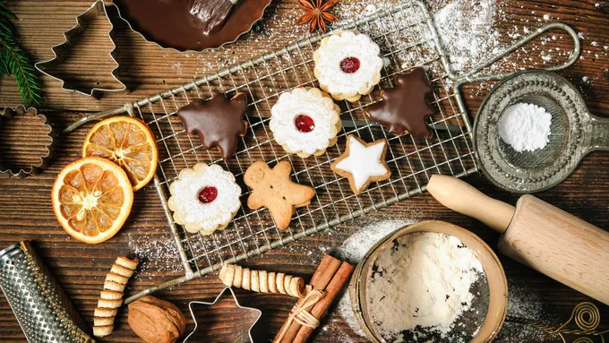 a table topped with cookies and cookies cutters