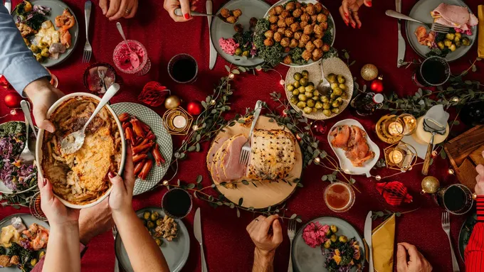 a group of people sitting around a table with food