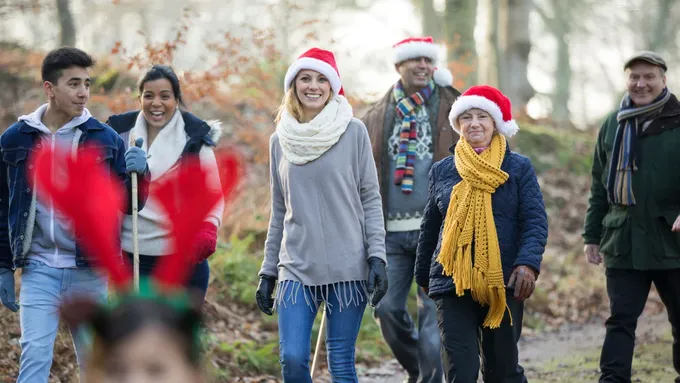 a group of people wearing christmas hats and scarves