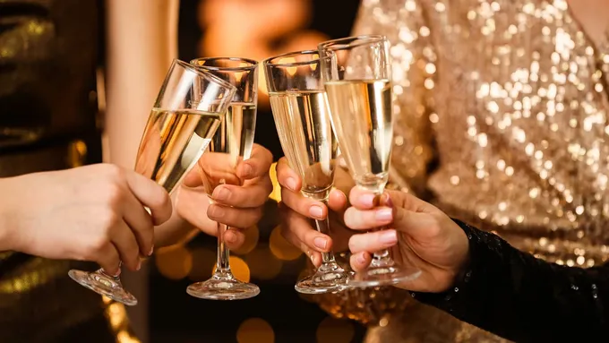 a group of people holding champagne flutes in their hands