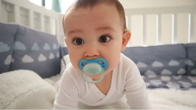 a baby with a pacifier in his mouth