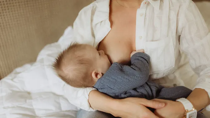 a woman holding a baby in her lap