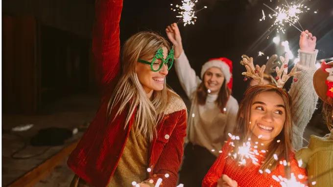 a group of people standing around each other holding sparklers