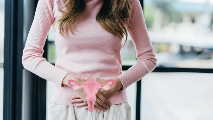 a woman in a pink sweater