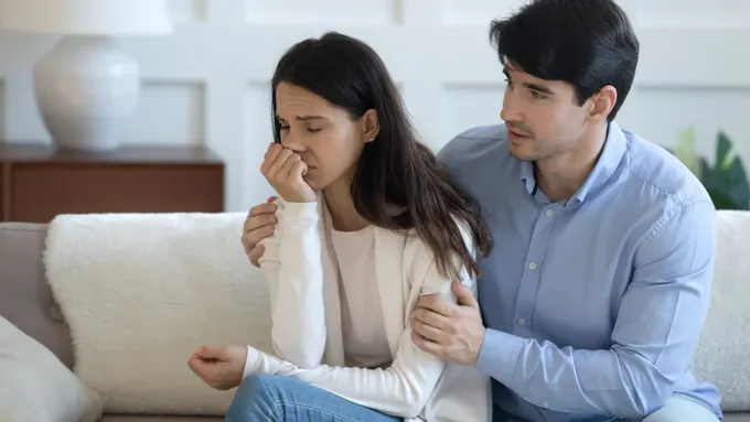 a man and a woman sitting on a couch