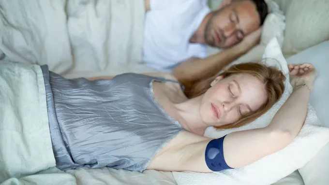 a man and a woman sleeping on a bed