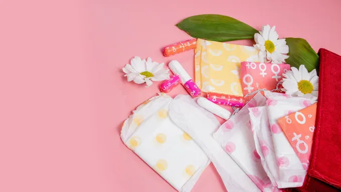 a bunch of cloths and a flower on a pink background