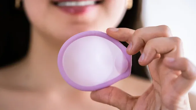 a close up of a person holding a cervical cap