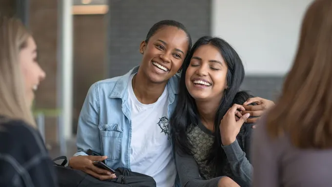 a couple of women sitting next to each other