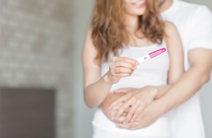 A couple interpreting an ovulation test.