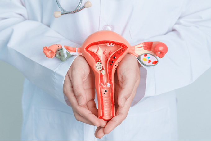 a doctor holding a model of the utensil in his hands