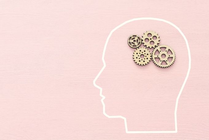 a person's head with gears in the shape of a head