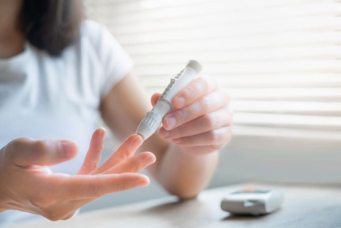 a woman is holding a thermometer in her hands