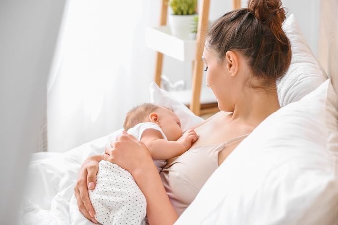 a woman holding a baby in her arms