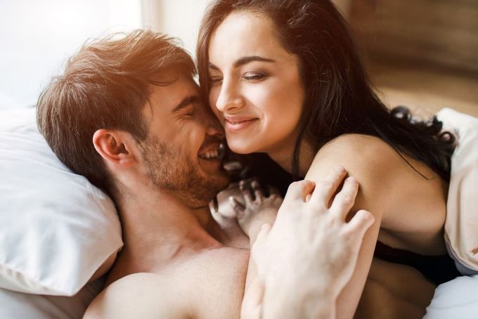 a man and a woman laying in bed together