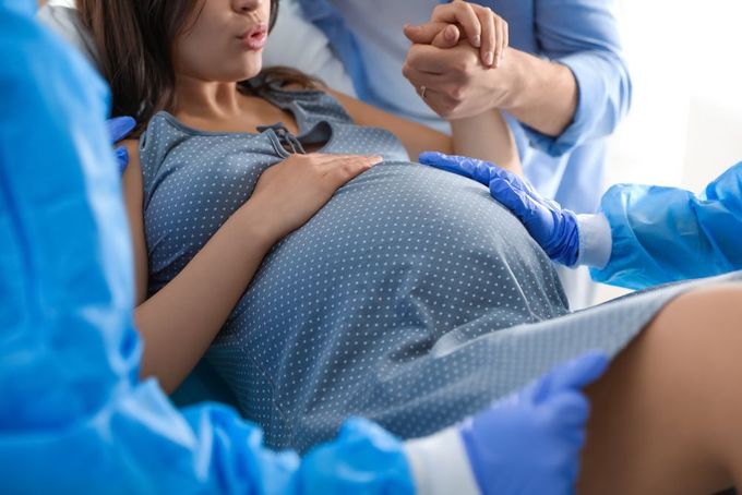 a pregnant woman is being examined by a doctor