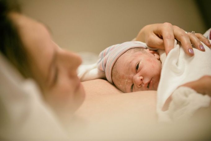 a woman holding a baby in her arms