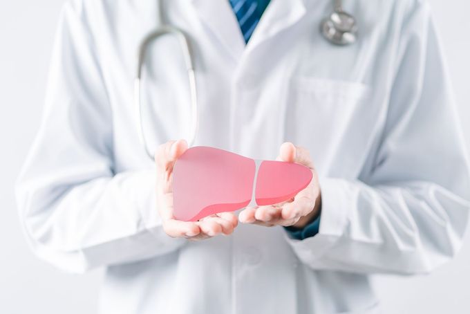 a doctor holding a broken heart in his hands