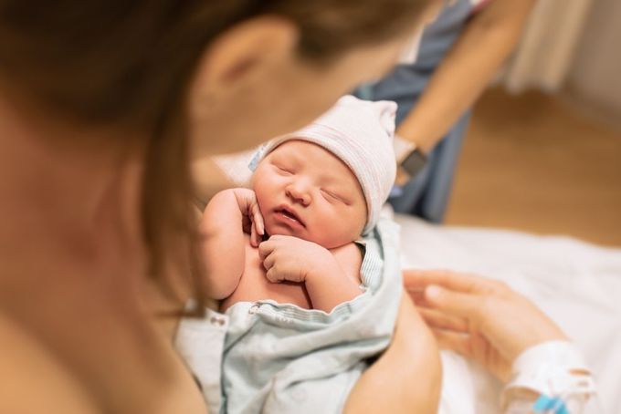 a woman holding a baby in her arms
