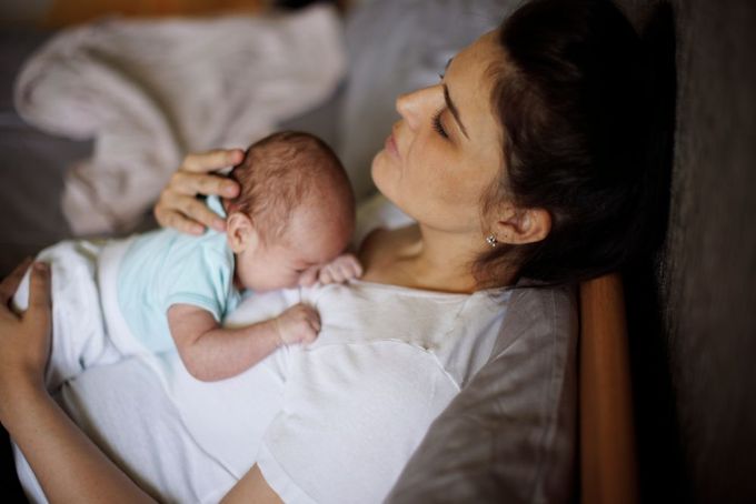 a woman holding a baby in her arms