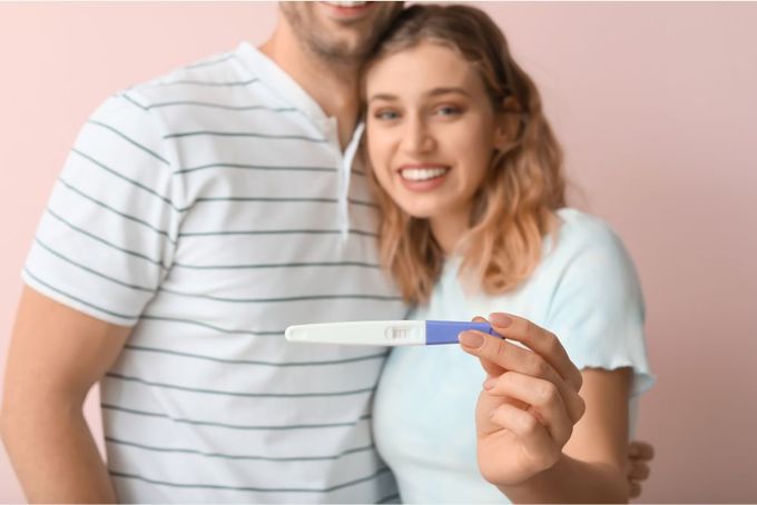 Positive pregnancy test a man and a woman are holding a toothbrush