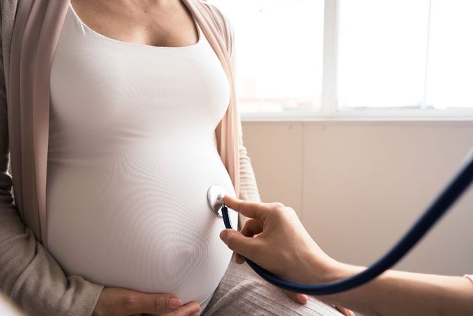 a pregnant woman being examined by a doctor