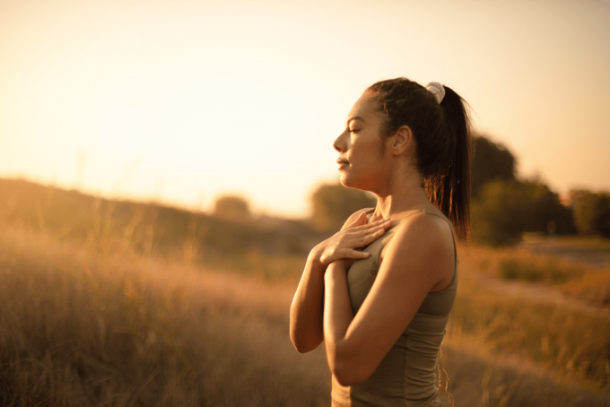 Stress management through deep breathing and meditation Woman practicing calm stress management and deep breathing to prevent cortisol steal and support hormonal health.