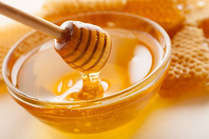 a honey dip with a wooden spoon in it
