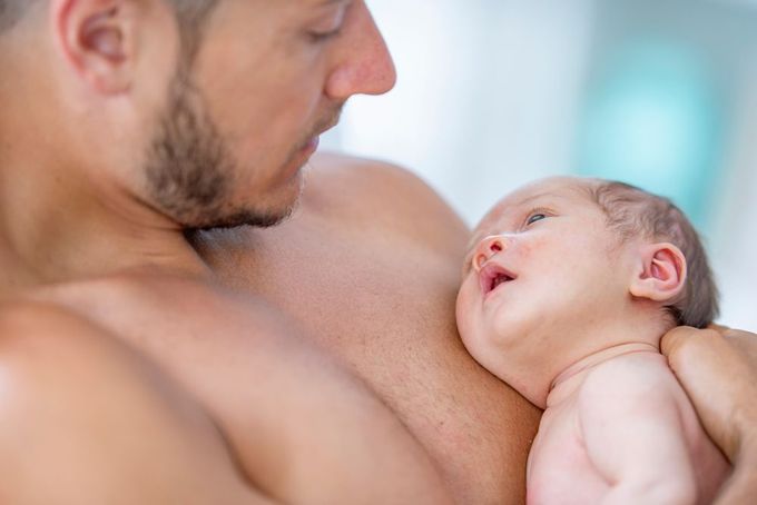 a man holding a baby in his arms
