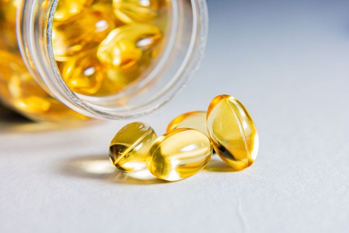 a glass jar filled with fish oil capsules